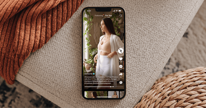 Phone showing a viral jelly bra TikTok video next to the physical bra